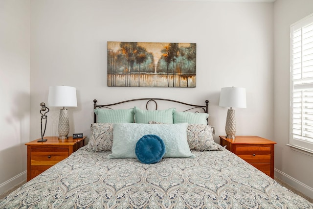 bedroom with multiple windows and baseboards