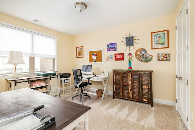 carpeted office featuring baseboards and visible vents