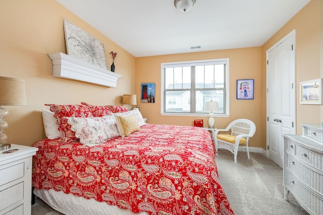 carpeted bedroom featuring visible vents and baseboards