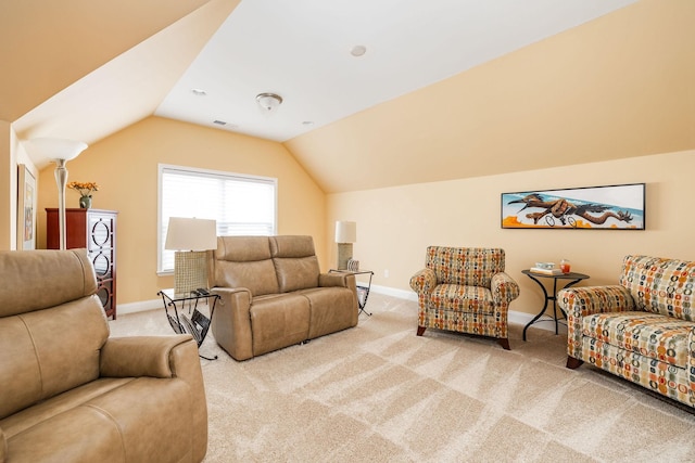 carpeted living room with lofted ceiling and baseboards