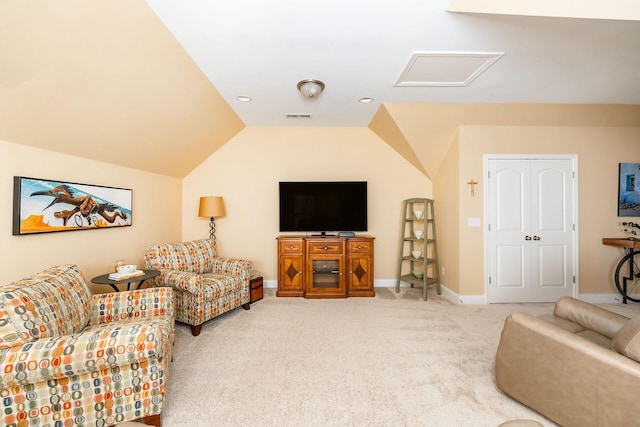 living area with attic access, visible vents, baseboards, lofted ceiling, and carpet