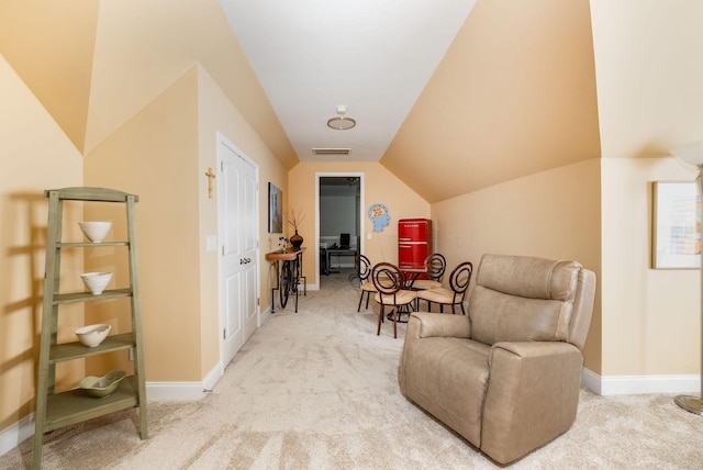 sitting room featuring vaulted ceiling, carpet, visible vents, and baseboards