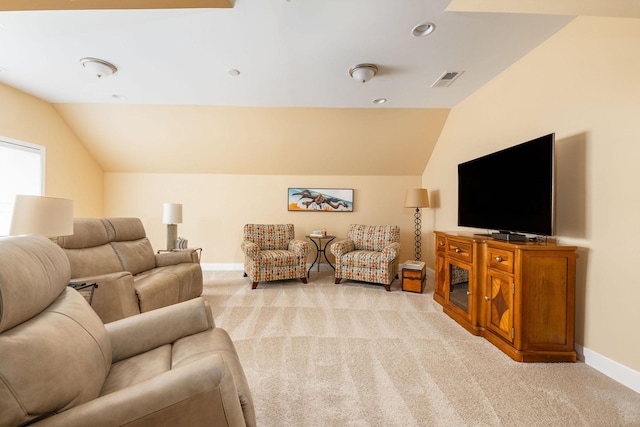 living area with light carpet, lofted ceiling, visible vents, and baseboards