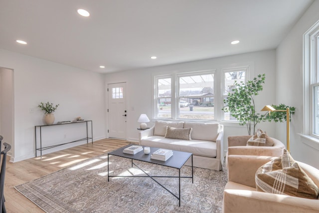 living room with baseboards, wood finished floors, and recessed lighting