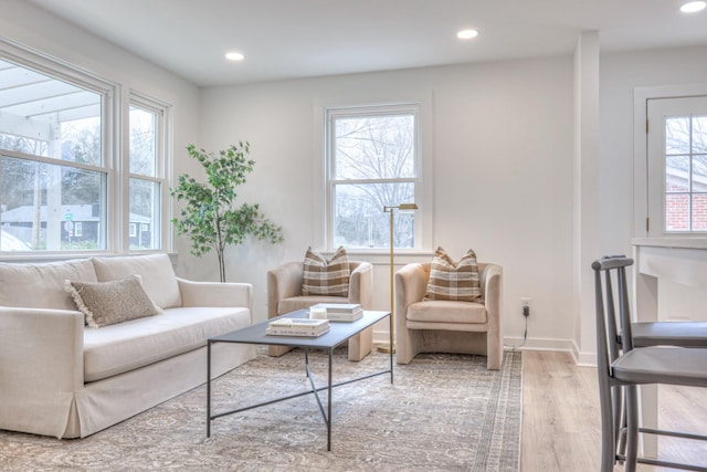 living room with a wealth of natural light, wood finished floors, and recessed lighting