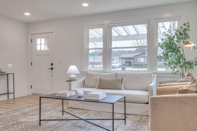 living room with baseboards, wood finished floors, and recessed lighting