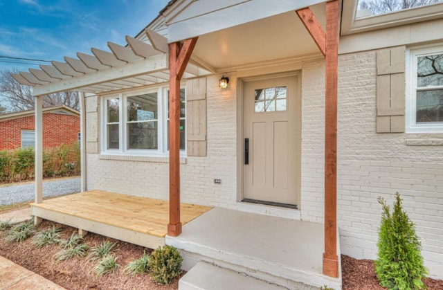 doorway to property with brick siding