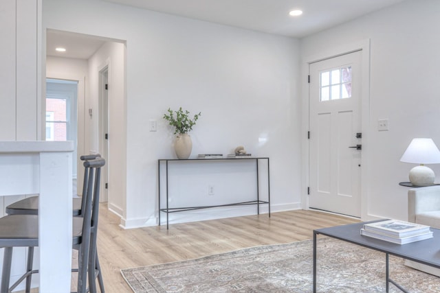 foyer featuring recessed lighting, baseboards, and wood finished floors