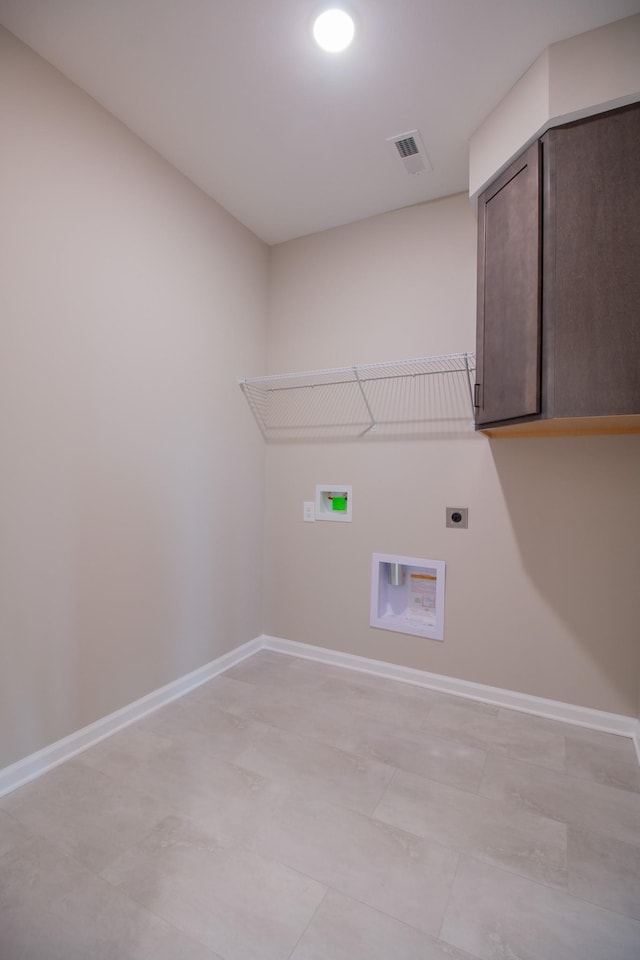 laundry room featuring hookup for a washing machine, visible vents, baseboards, cabinet space, and electric dryer hookup