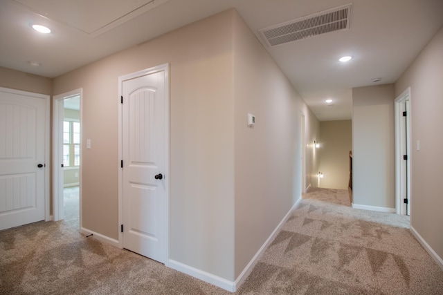 hall featuring visible vents, an upstairs landing, recessed lighting, carpet flooring, and baseboards