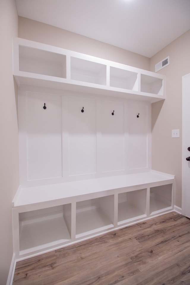 mudroom with visible vents and wood finished floors