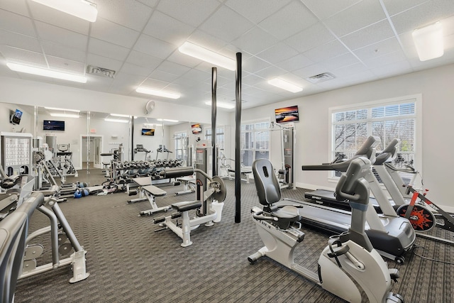 workout area with carpet floors, baseboards, visible vents, and a paneled ceiling