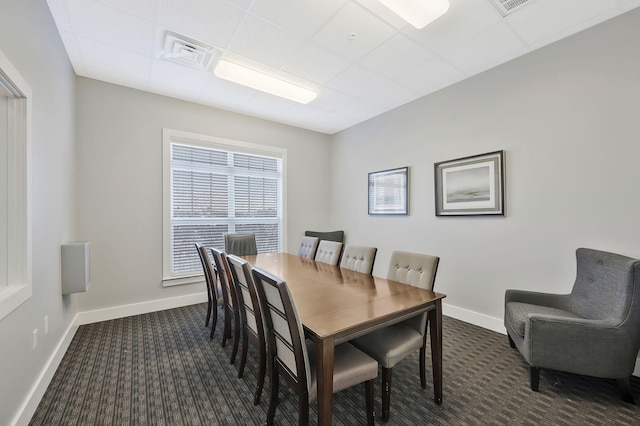 dining area with dark colored carpet, visible vents, and baseboards