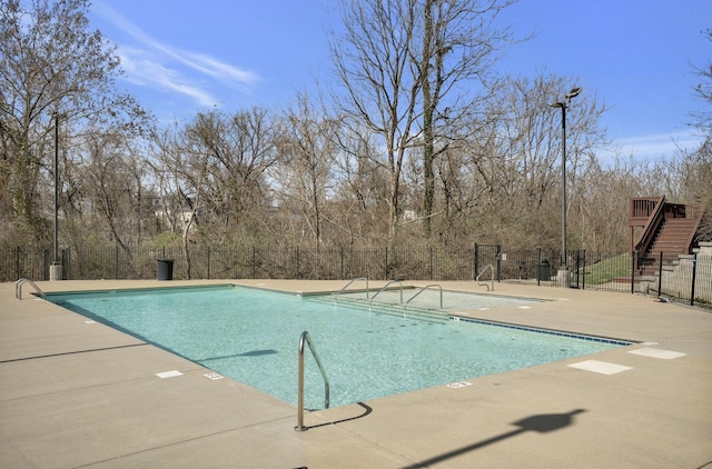 pool featuring a patio and fence