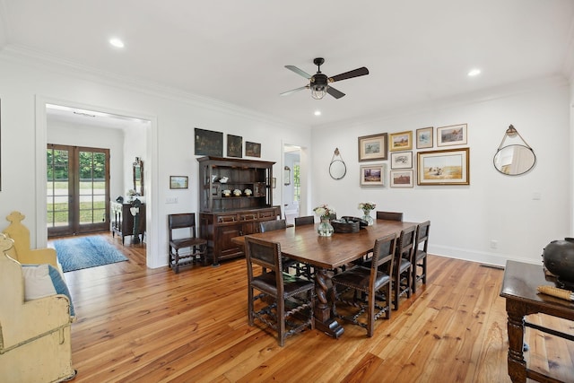 dining space with crown molding, light wood-style flooring, and baseboards