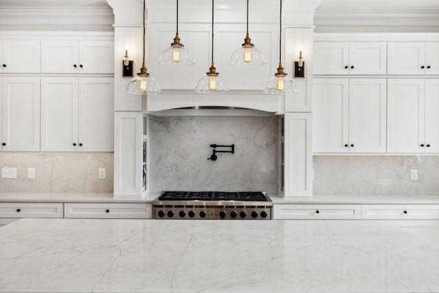 kitchen featuring pendant lighting, tasteful backsplash, white cabinets, and stainless steel gas stovetop