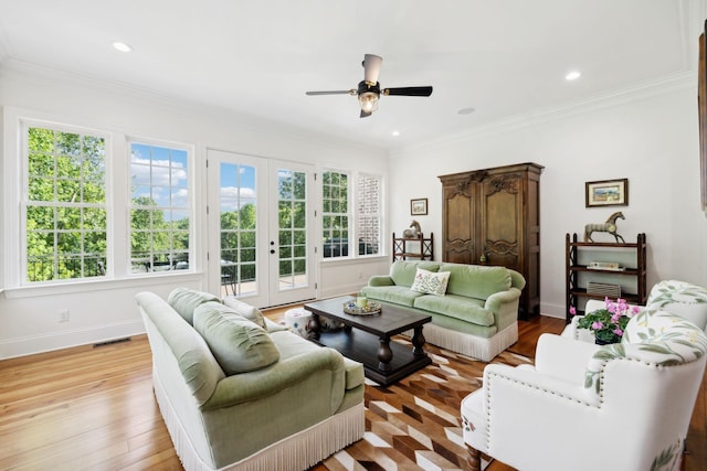 living room featuring light wood-style floors, plenty of natural light, baseboards, and french doors