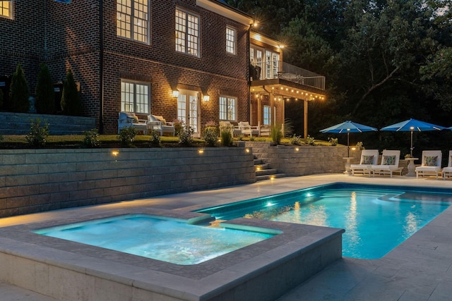 view of swimming pool with a fenced in pool, a patio, and an in ground hot tub