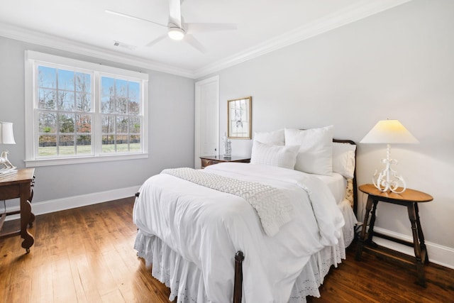 bedroom featuring wood-type flooring, visible vents, and crown molding