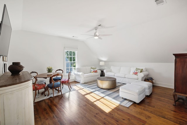 living room featuring vaulted ceiling, hardwood / wood-style floors, visible vents, and a ceiling fan