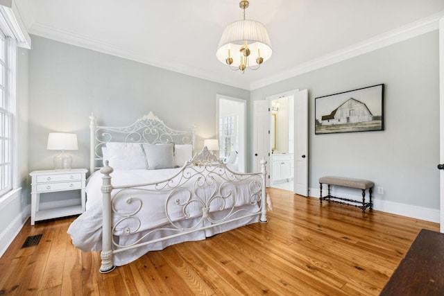 bedroom with ornamental molding, wood-type flooring, and multiple windows