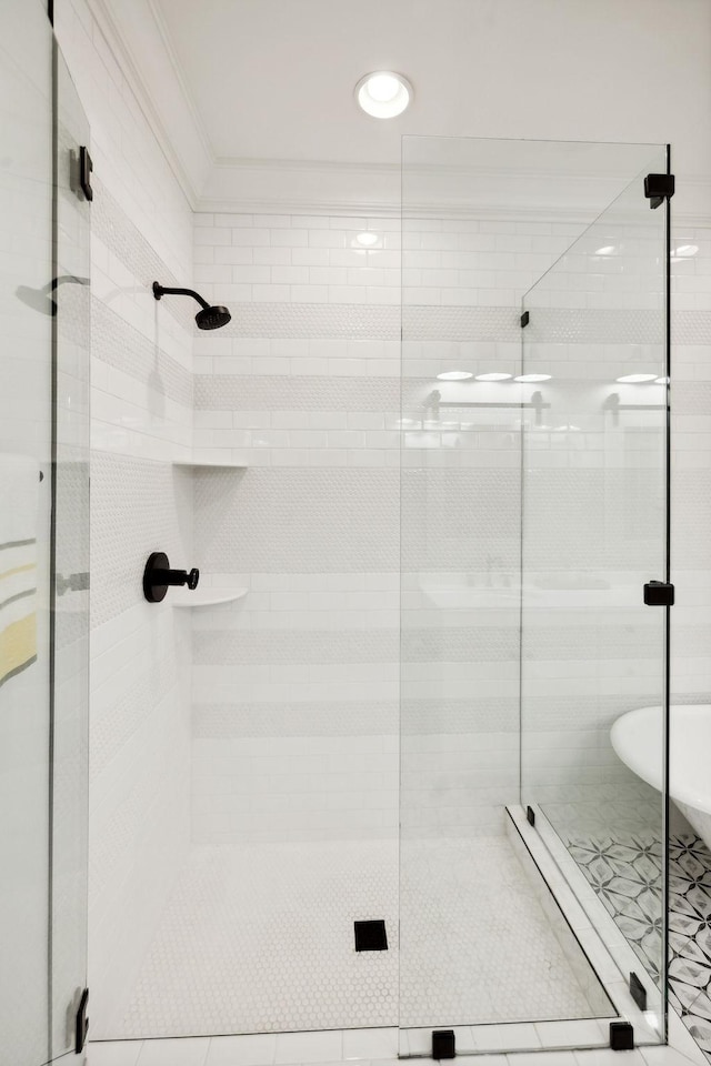 bathroom featuring ornamental molding and a stall shower