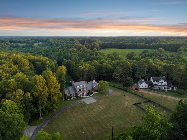 drone / aerial view with a forest view and a rural view