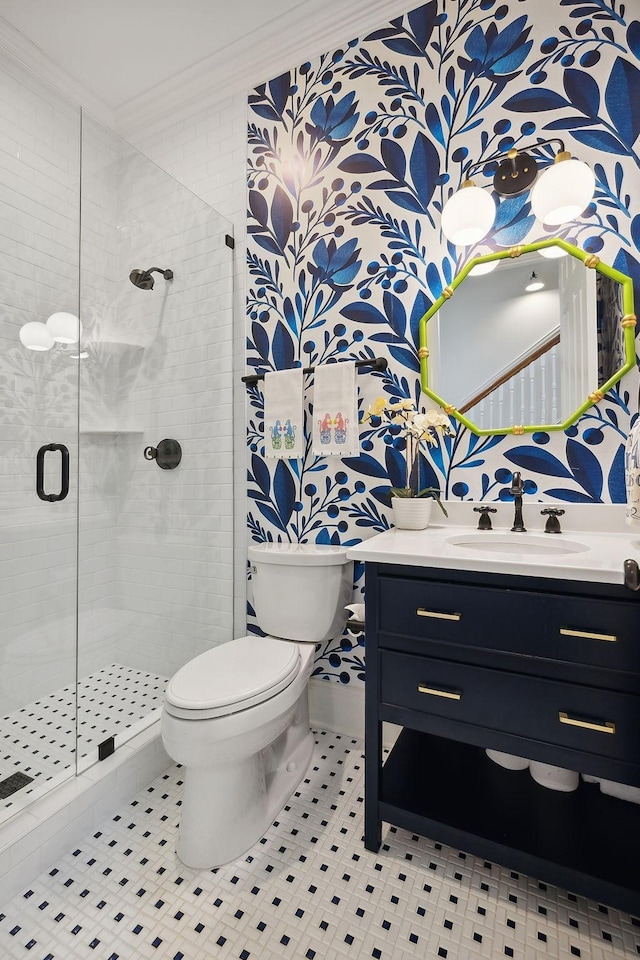 bathroom featuring a stall shower, vanity, toilet, and crown molding