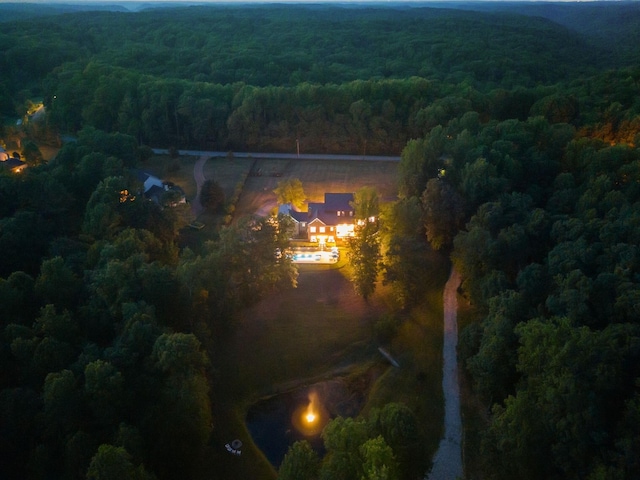 drone / aerial view featuring a wooded view