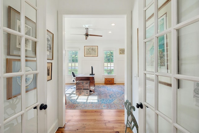 interior space featuring recessed lighting, light wood-type flooring, and crown molding