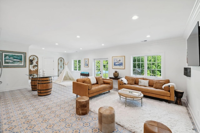 living room featuring baseboards, visible vents, crown molding, and recessed lighting