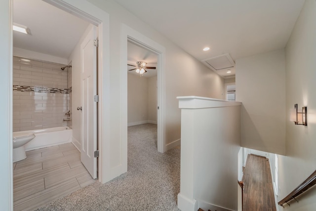 hallway with recessed lighting, attic access, an upstairs landing, and baseboards