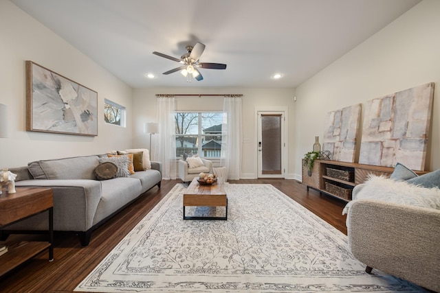 living area featuring baseboards, a ceiling fan, dark wood-style flooring, and recessed lighting