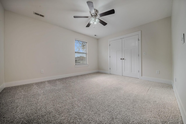 unfurnished bedroom featuring a closet, carpet flooring, visible vents, and baseboards