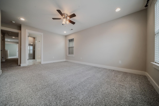 unfurnished room with light carpet, ceiling fan, baseboards, and recessed lighting