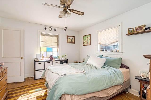 bedroom featuring a ceiling fan and wood finished floors