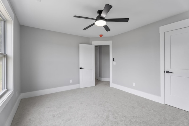 unfurnished bedroom featuring ceiling fan, carpet flooring, and baseboards