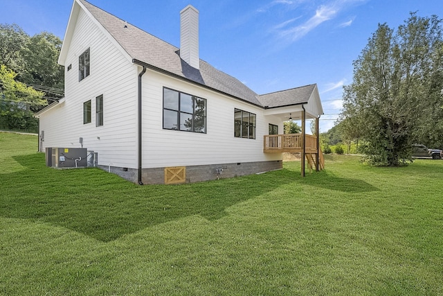 view of side of home with crawl space, a yard, a chimney, and central air condition unit