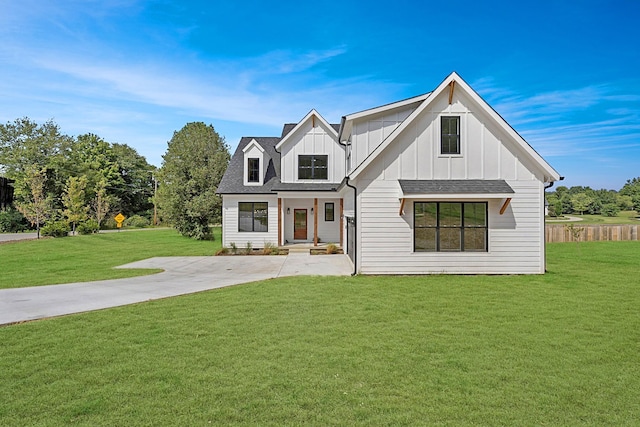 modern farmhouse featuring board and batten siding and a front yard