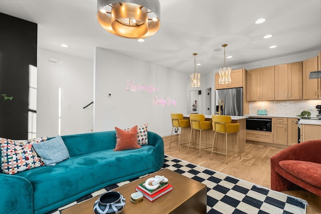 living room featuring stairs, light wood-style flooring, and recessed lighting