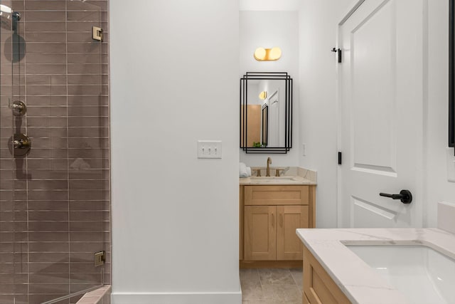 bathroom featuring a stall shower, two vanities, and a sink