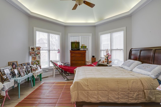 bedroom featuring baseboards, a ceiling fan, and wood finished floors