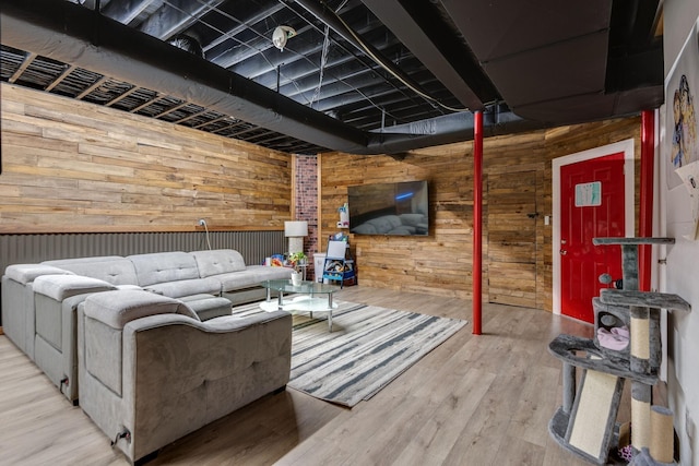 living area featuring wood walls and wood finished floors