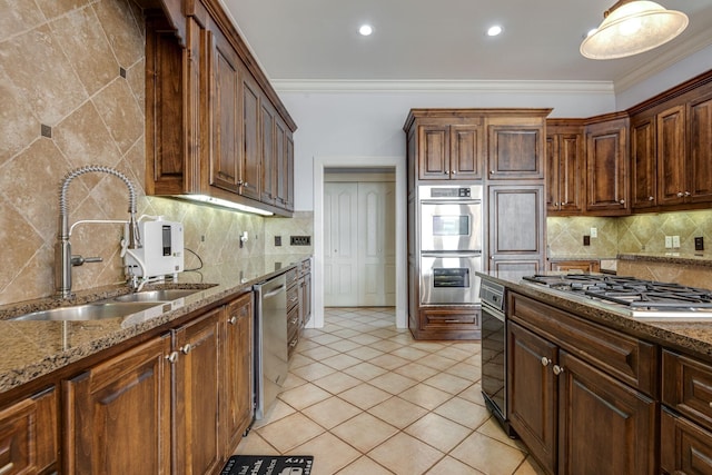 kitchen featuring stainless steel appliances, decorative backsplash, a sink, and crown molding