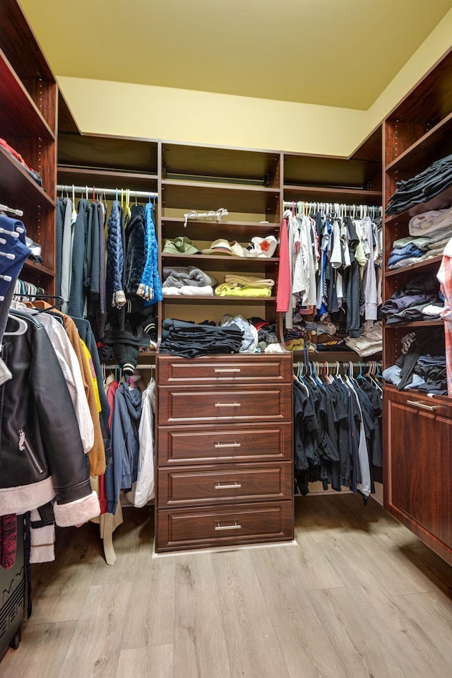 walk in closet with light wood-type flooring