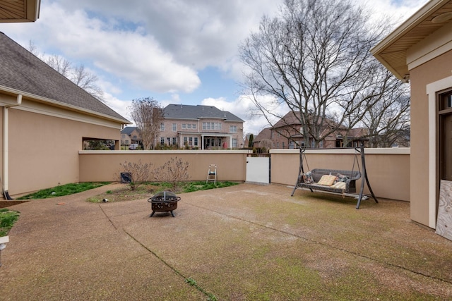 view of patio with an outdoor fire pit and fence