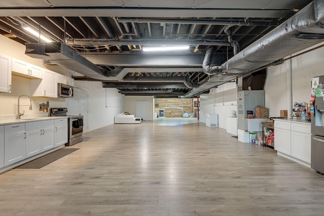 garage with a sink and stainless steel fridge with ice dispenser