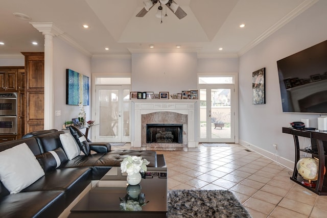 living room featuring recessed lighting, ornamental molding, a high end fireplace, light tile patterned flooring, and baseboards