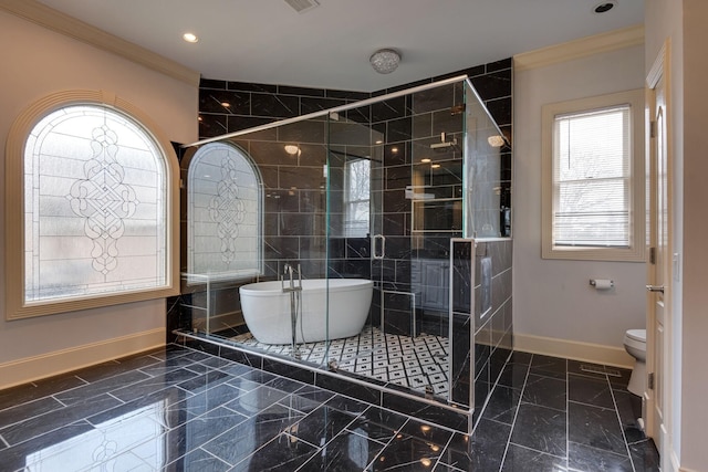 bathroom featuring a stall shower, marble finish floor, crown molding, and a soaking tub