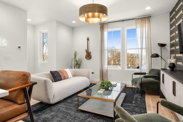 living area featuring a wealth of natural light, baseboards, recessed lighting, and wood finished floors